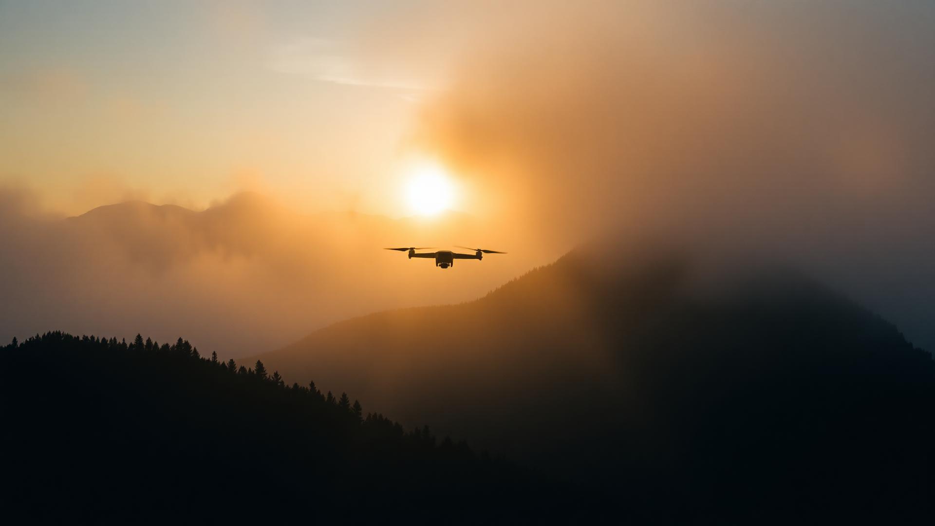 Aerial view of misty mountains at golden hour